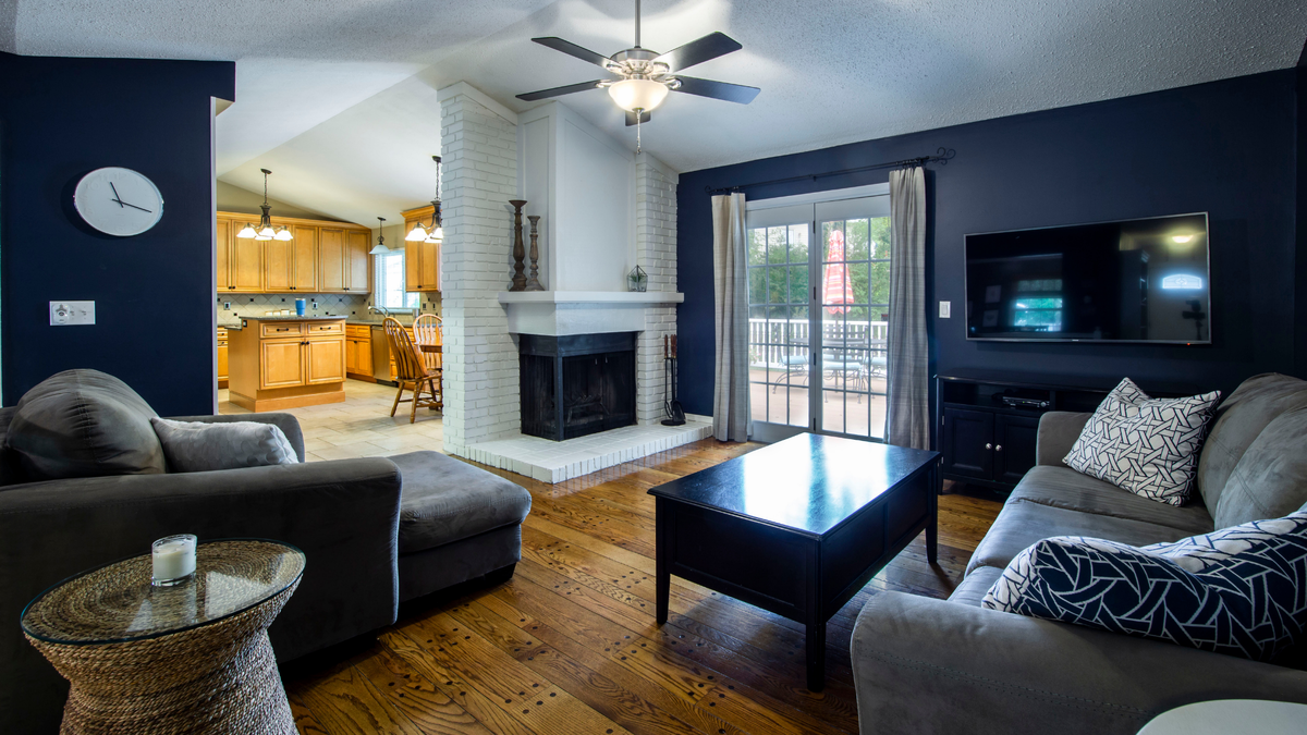 Apartment With A Retractable Interior Wall Dark wood floors living room, Living 