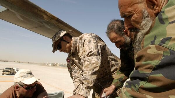    CC BY 2.0 / ResoluteSupportMedia / Petty Officer 2nd Class David Kolmel / Latvian Mentor assists Afghan Air Force with Maintenance