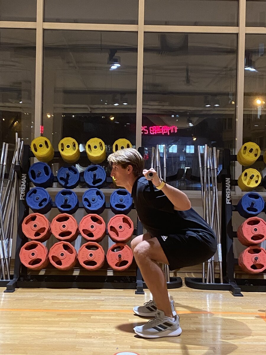 Медленно присядьте до уровня, когда бедра станут почти параллельны полу.Выполняя движение вниз, представьте, что вы садитесь на стул, удерживая спину в прямом положении. Вес тела распределите равномерно на всю стопу от пятки до пальцев. Активно отталкивайтесь от пола. Медленно вернитесь в положение стоя. 