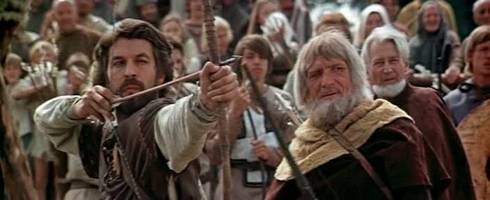 Робин стреляет в мишень на празднике ( в гл. роли Борис  Хмельницкий)