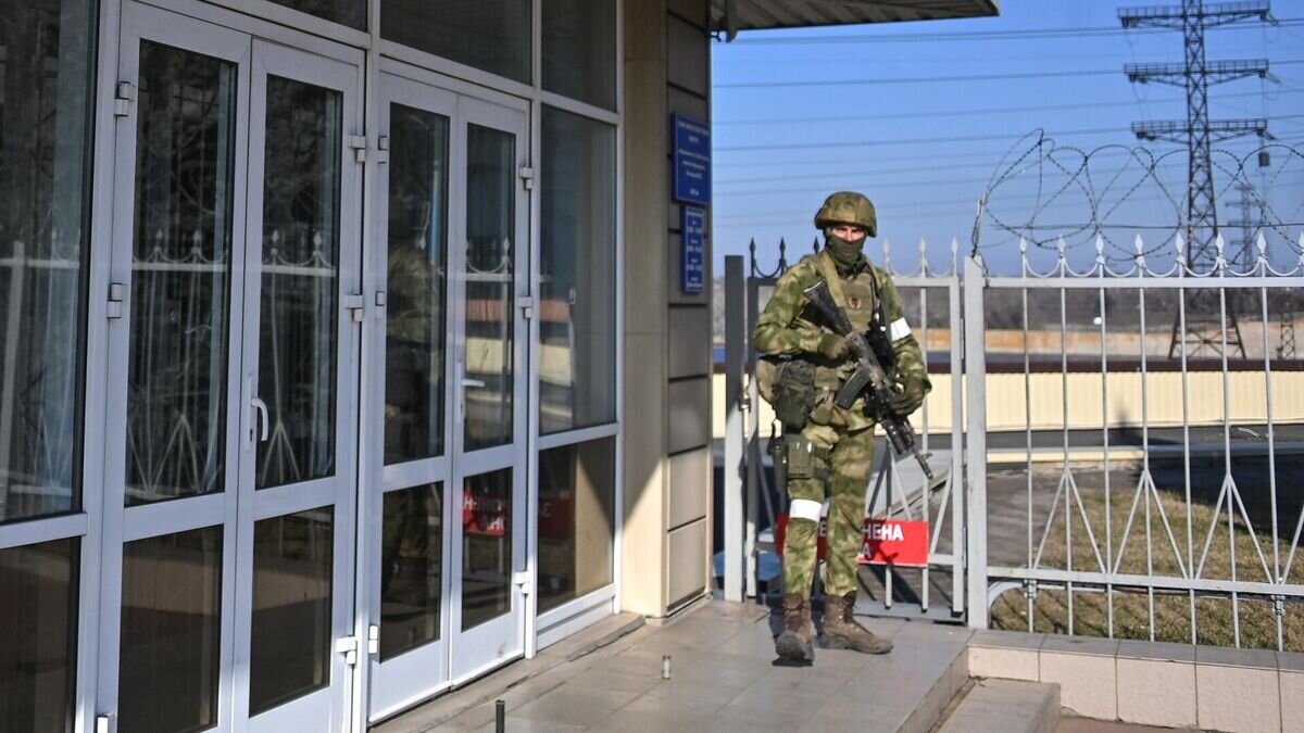    Сотрудник Росгвардии возле здания Каховской ГЭС© РИА Новости / РИА Новости