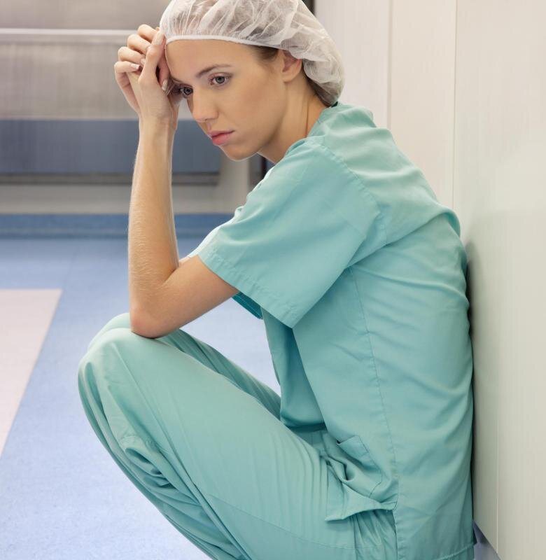 https://images.practicaladultinsights.com/tired-female-doctor-sitting-against-wall.jpg