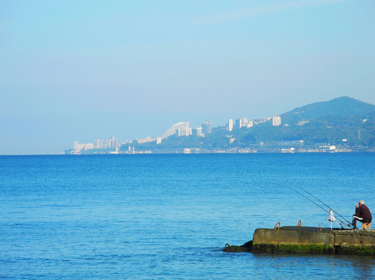 Рыбак на пристани в городе Адлер