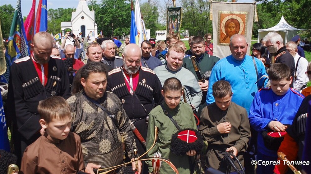 Собрались казаки перед священником. Молятся сами да слушают молитву. И крестятся. Ждут самого главного
