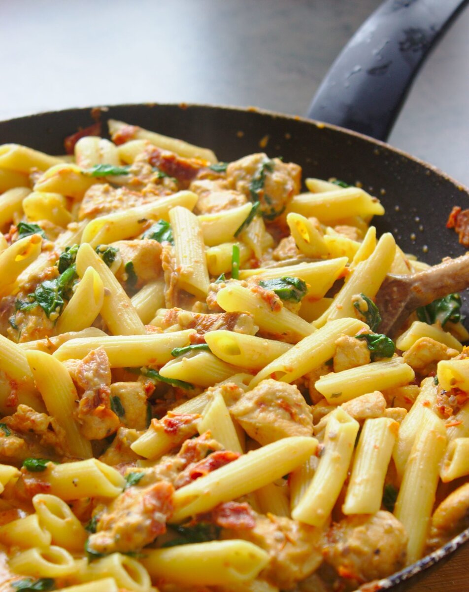 Количество порций: 6-8 
 Время на подготовку: 30 минут.

Ингредиенты
300 г пасты  пенне
600 г филе куриной грудки
1-2 столовые ложки  масла для жарки
120 мл овощного или птичьего бульона
300 г сушеных помидоров в масле (слить количество)
150 г свежего шпината 
1 чайная ложка сливочного масла
3 шарика сыра моцарелла
4 зубчика чеснока
120 мл сливок 12% (сладкий кофейный крем)
350 мл молока 3,2%
ПАНИРОВОЧНЫЕ СУХАРИ:

1/4 чайной ложки порошка чили
1/4 чайной ложки сладкого перца
1/4 чайной ложки соли