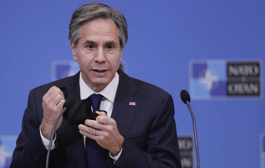 epa09093294 US Secretary of State Antony Blinken takes off his face mask as he gives a press briefing at the end of a NATO Foreign Ministers' meeting at the Alliance's headquarters in Brussels, Belgium, 24 March 2021. The foreign ministers met in person for the first time in more than a year as they preparing for an upcoming summit by discussing a set of proposals to reform the military alliance. EPA-EFE/OLIVIER HOSLET / POOL