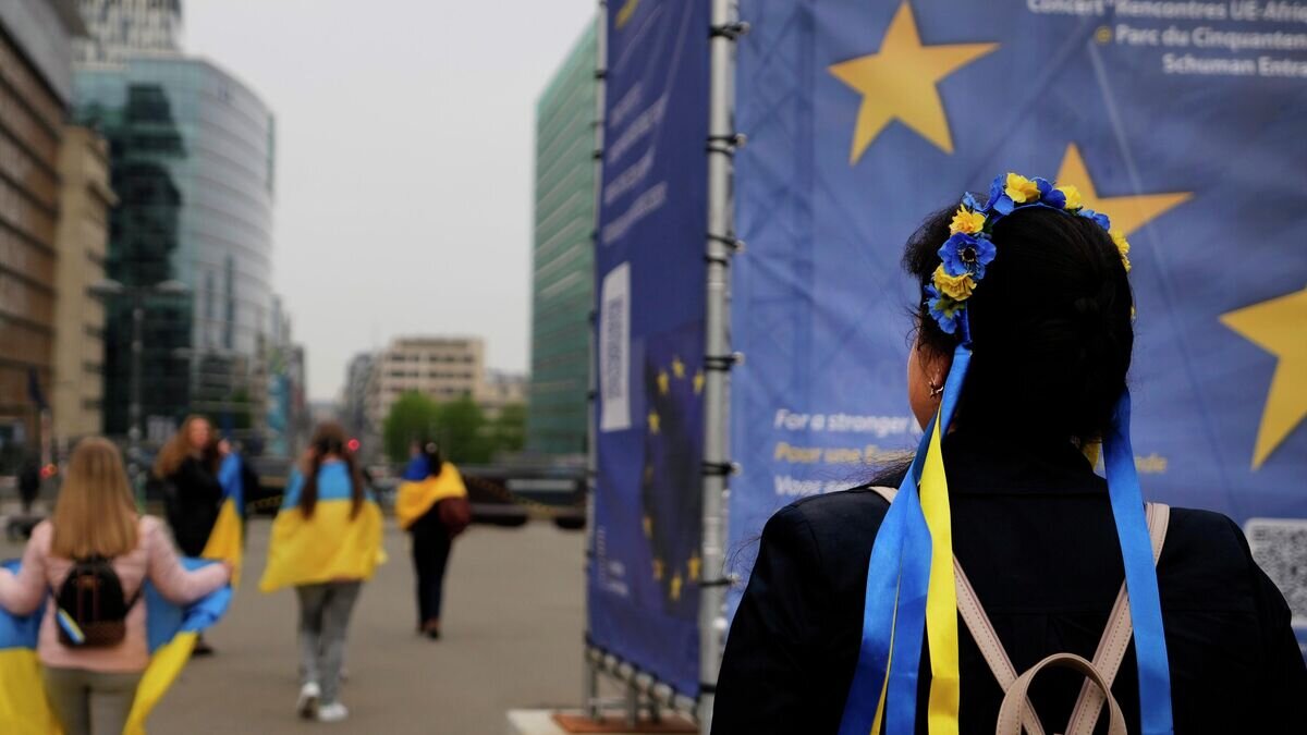    Протестующие несут украинские флаги, принимая участие в демонстрации возле штаб-квартиры ЕС в Брюсселе© AP Photo / Virginia Mayo