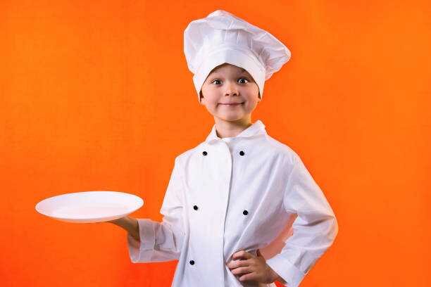    funny boy chef keeps a plate on an orange background Виталий Веселов