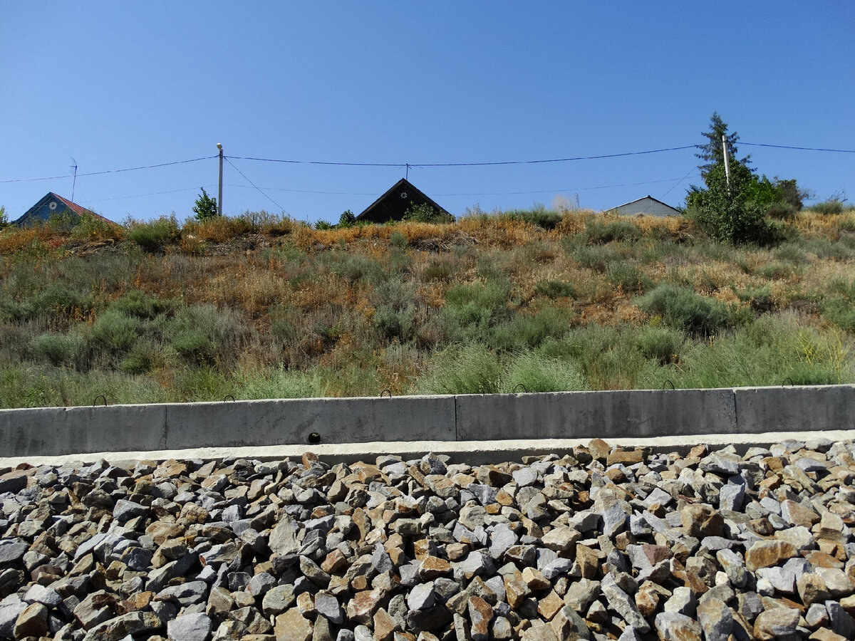 На заднем плане - дома на улице Набережной. На переднем виден укреплённый берег