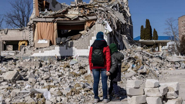 Люди смотрят на разрушенное здание школы в Житомире, Украина. Обложка © Getty Images / Chris McGrath