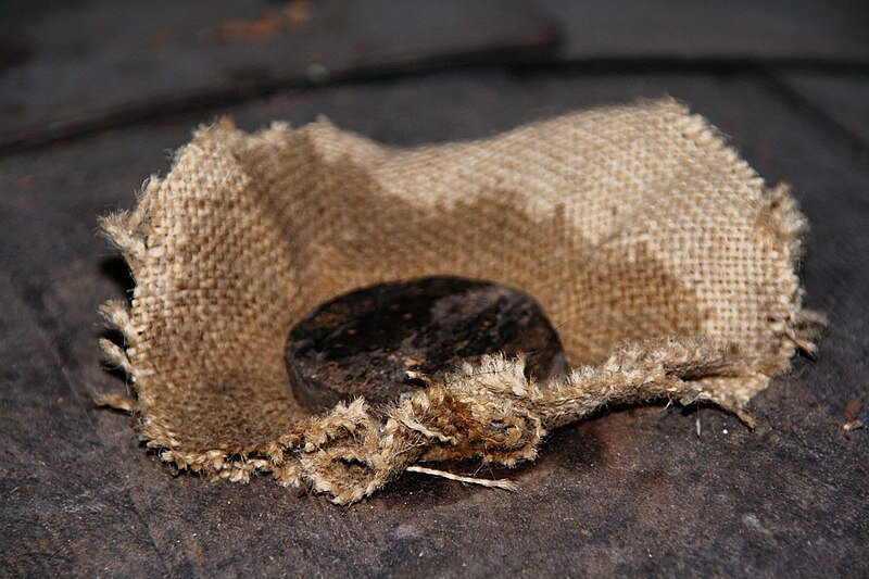 A wood stopper on a full barrel of Cognac. Photo taken in a wine farm in Cherves de Cognac, Charente, Poitou-Charentes, France. 
Sémhur