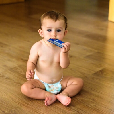    Baby playing with a bank credit card from his parents. Валерий