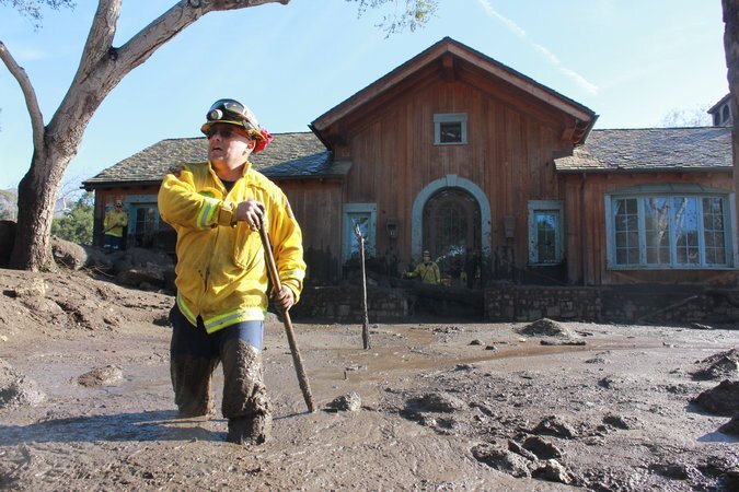 (Alex Jimenez of Cal Fire searched for survivors on East Valley Road in Montecito. Credit Sky Gilbar for The New York Times)