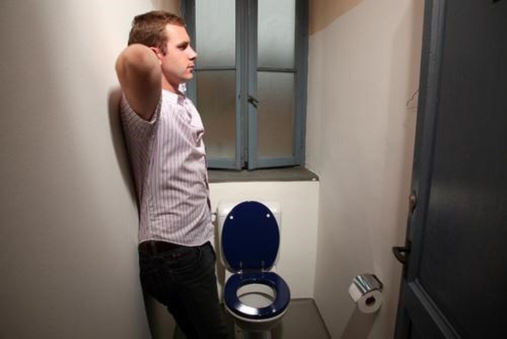 Мужчины терпят в туалет. Мужчина в туалете.