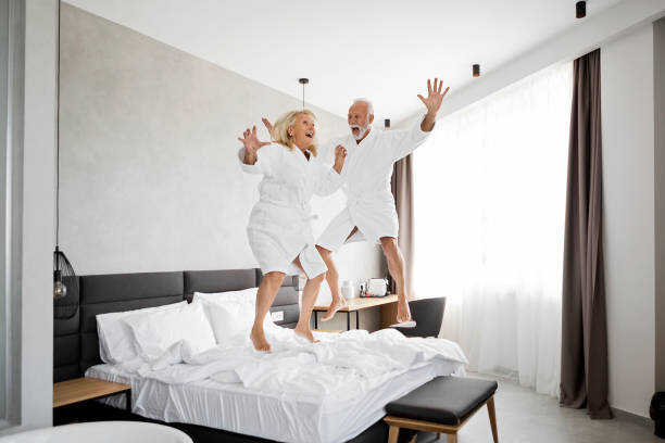 https://media.istockphoto.com/photos/senior-couple-having-fun-in-hotel-room-jumping-on-a-bed-picture-id1172285249?k=6&m=1172285249&s=612x612&w=0&h=kMYsEjDW4_B72EcyCLXWV3AsA0pSB1qZH_WRSaVctyQ=