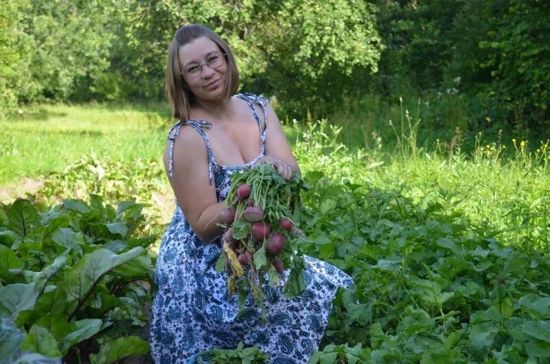 Между грядок с овощами на огороде.