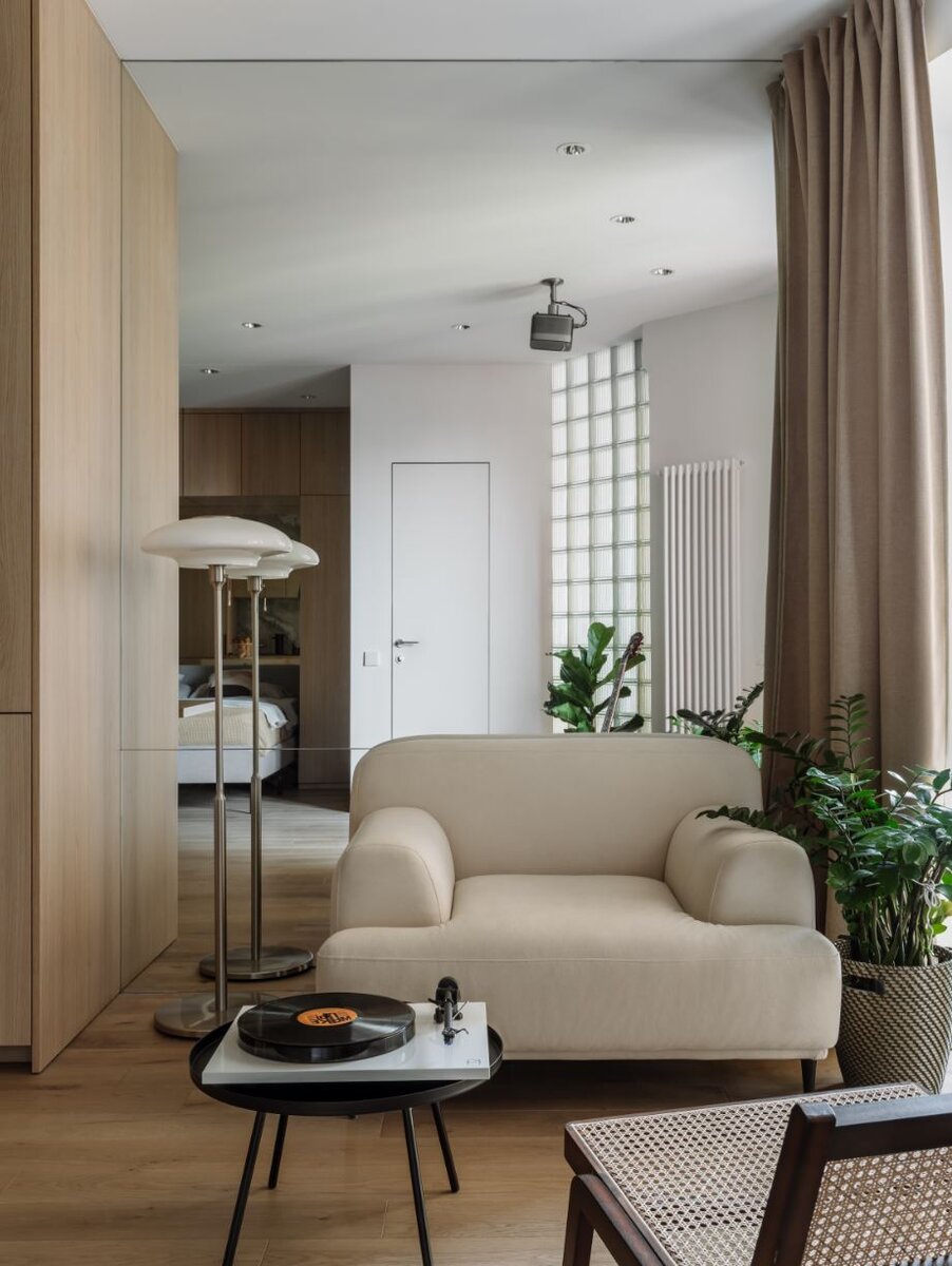 Гостиная. Кресло, “Огого-обстановочка”; плетеное кресло и столик, H&M Home; торшер, шторы, кашпо и ящик для пластинок, Ikea; на полу инженерная доска, Finex.Фотограф: Ольга Шангина-Лестерлен. Стилист: Екатерина Наумова