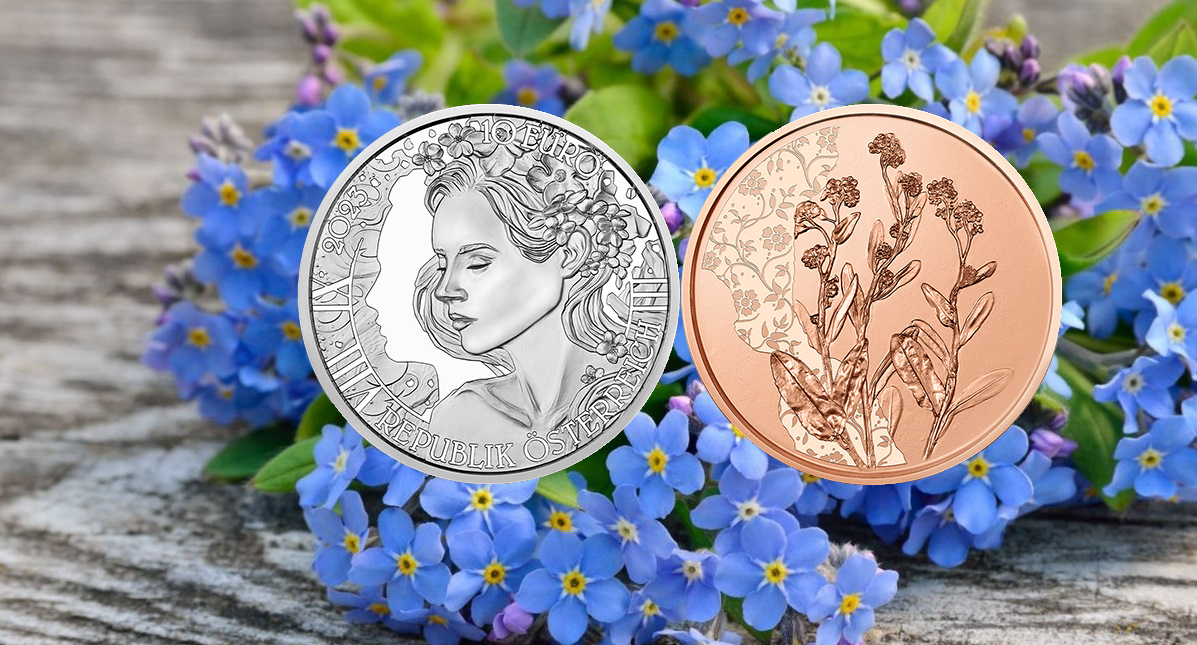 Новые монеты Австрии на фоне незабудок.