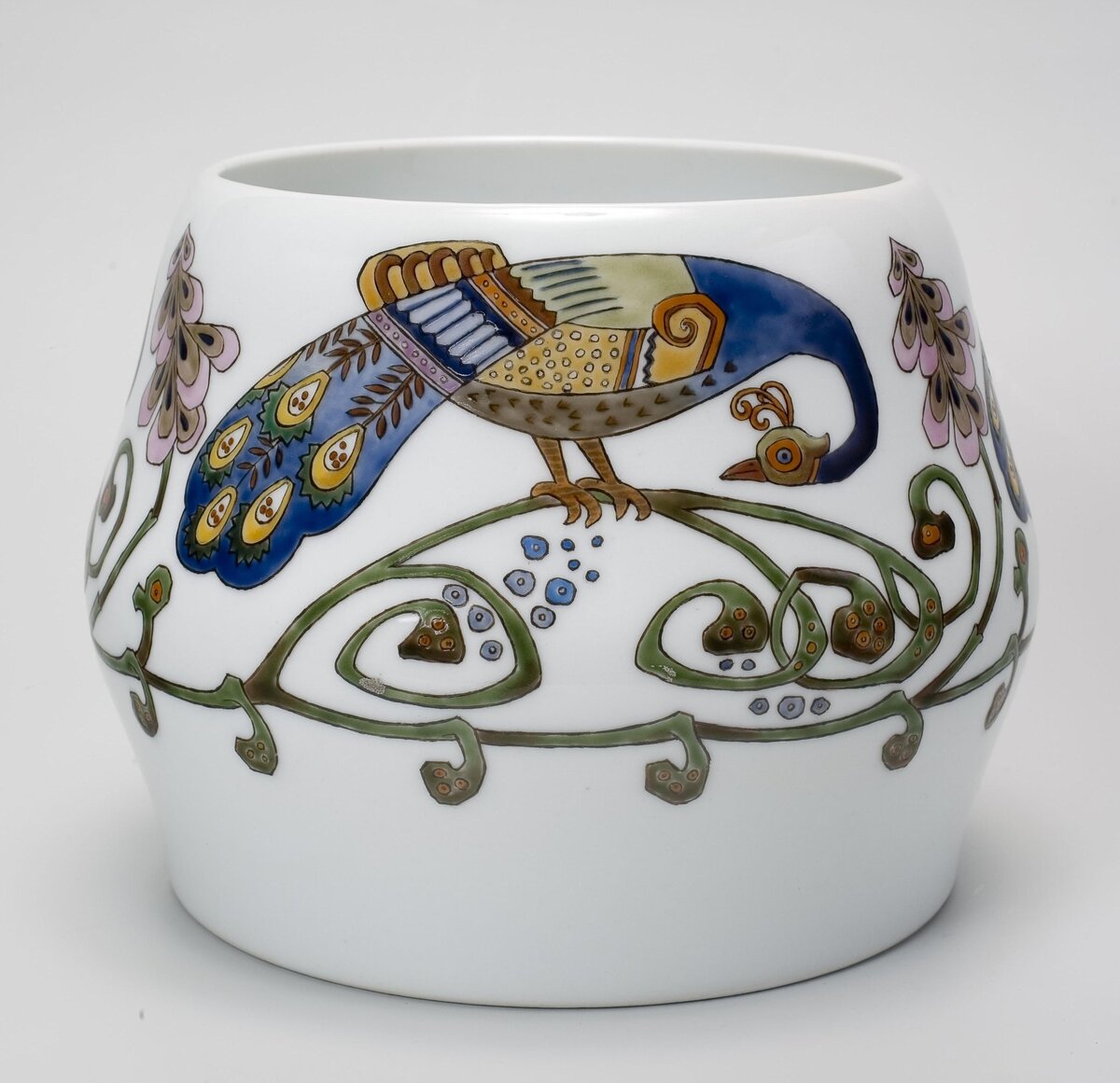 Эта вазочка расписана в одном из сугубо национальных направлений раннего МОДЕРНА (АР-НУВО) - ПСЕВДОРУССКОМ СТИЛЕ. Называется "Павлины". ИФиСЗ, 1907. Автор композиции (эскиза) Вильде Р.Ф. Исполнитель - Шмаков М.В. Роспись полихромная эмалями, позолота. Размеры: 14,5*8,8*13,7 см. Собрание Эрмитажа. Предмет поступил в 2002-м году. Передан в составе коллекции Музея Фарфорового завода. Инв. номер Мз-С-1978. Изображение взято из каталога Эрмитажа. Листайте галерею вправо.