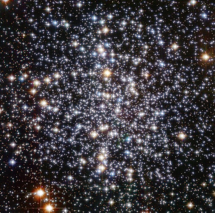    A Hubble Space Telescope image of the globular star cluster, Messier 4. The cluster is a dense collection of several hundred thousand stars. Astronomers suspect that an intermediate-mass black hole, weighing as much as 800 times the mass of our Sun, is lurking, unseen, at its core. [Image description: Thousands of bright points of light on a black background fill the field of view. They appear somewhat more concentrated near the centre of the image. They have a variety of colours, with the most prominent stars appearing blue or yellow-orange. The brighter stars also display four diffraction spikes.] Анастасия Никифорова