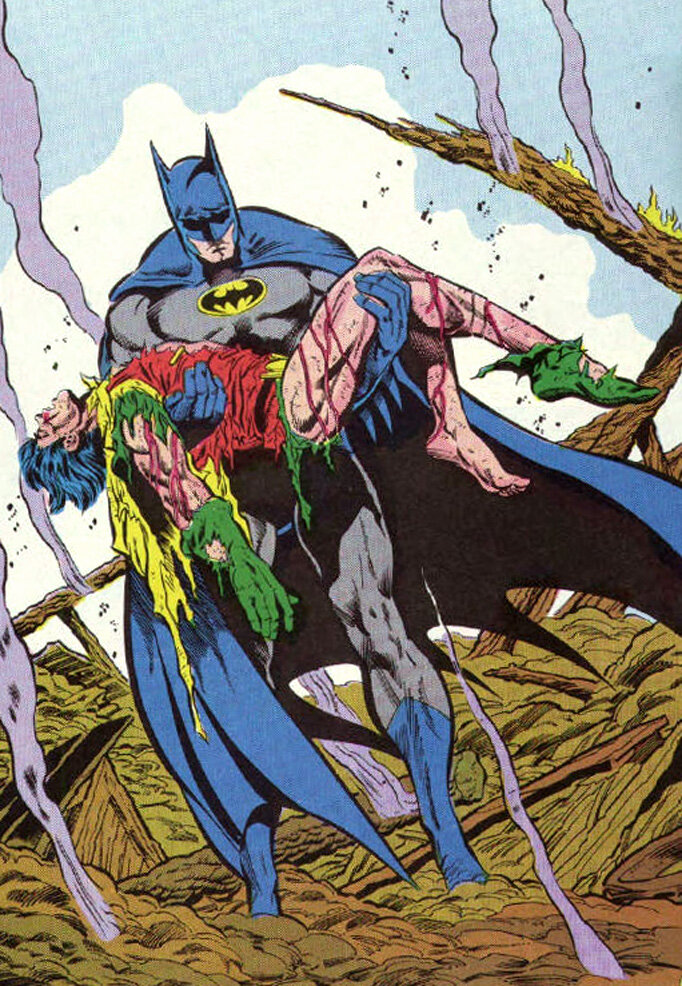 Бэтмен несет на руках второго Робина