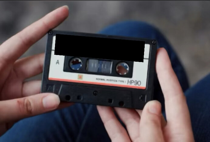 A photo of the cassette, in the girl's hand.