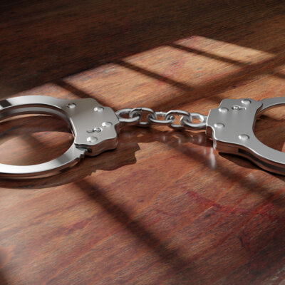    Jail bar shadow and handcuff on a wooden table, dark background. Prison, conviction and incarceration concept. 3d render Валерий