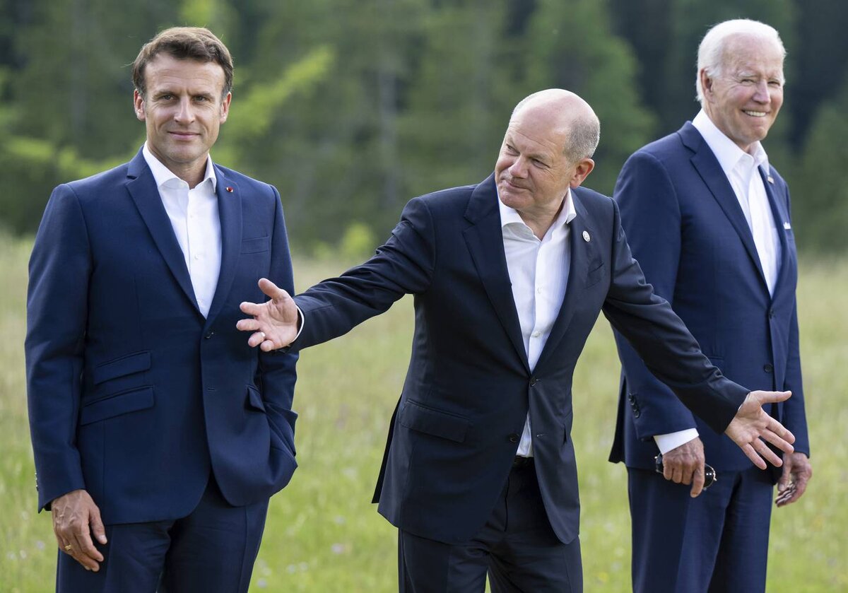    From left, Emmanuel Macron, Prime Minister of France, German Chancellor Olaf Scholz and U.S. President Joe Biden attend a family photo at Castle Elmau in Kruen, near Garmisch-Partenkirchen, Germany, on Sunday, June 26, 2022. The Group of Seven leading economic powers are meeting in Germany for their annual gathering Sunday through Tuesday. (Sven Hoppe/dpa via AP) kievb