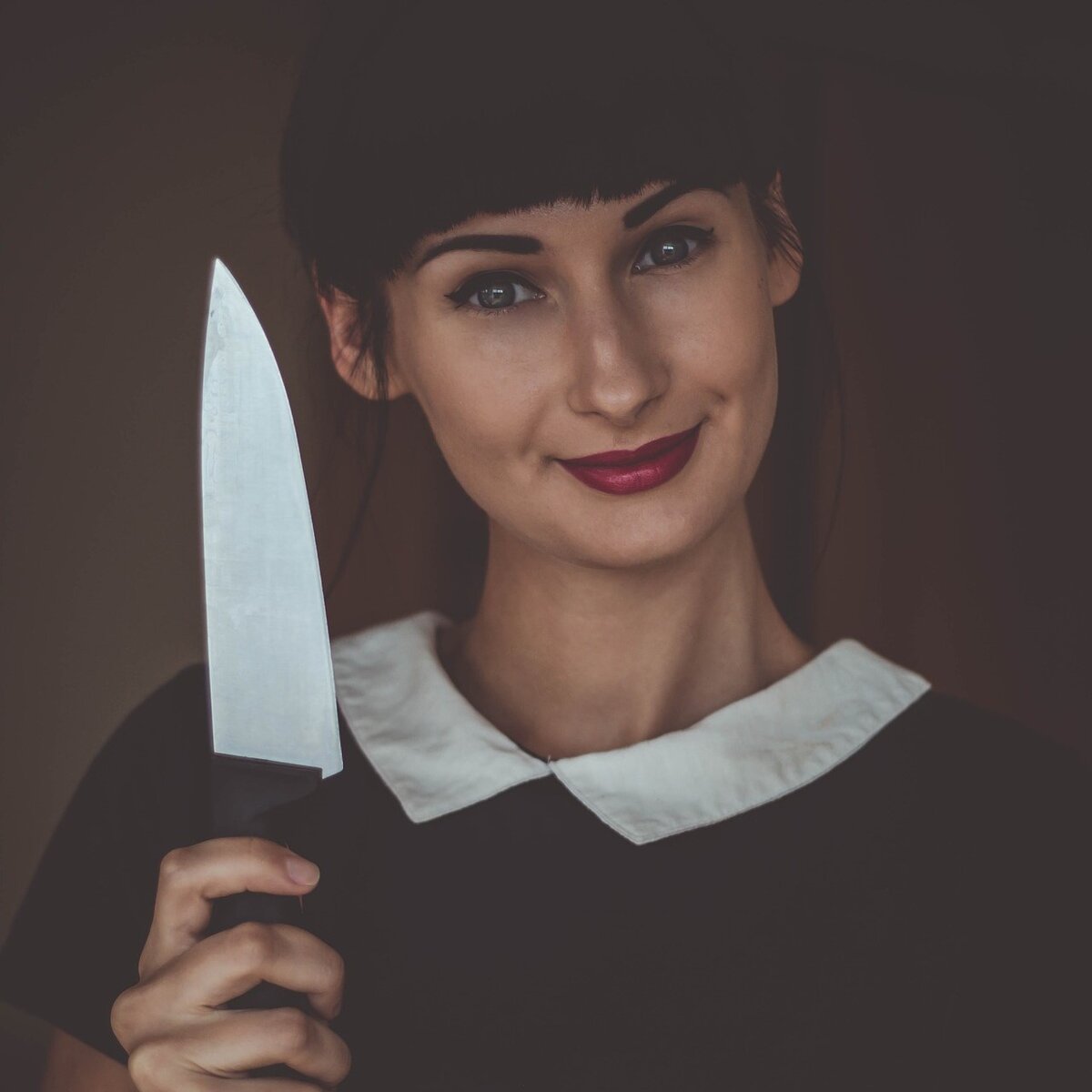 Женщина держит в руке нож