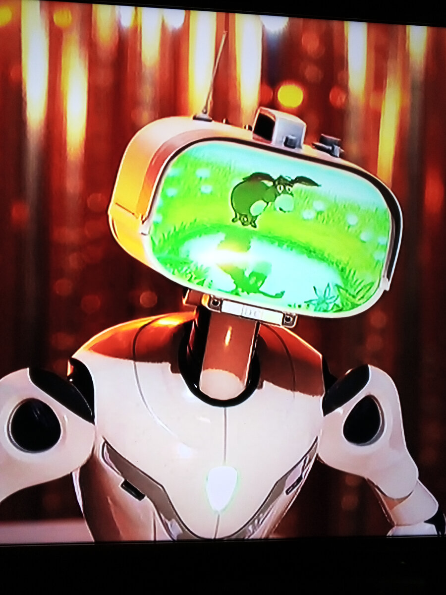 Виртуальный персонаж Телек,Оценивает выступление участников шоу