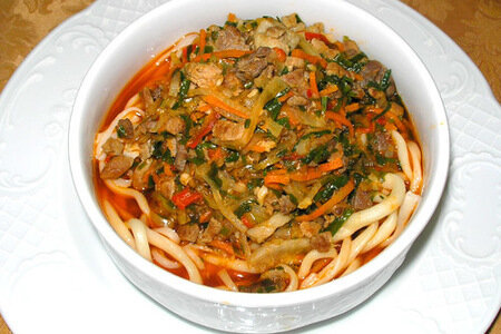 Ингредиенты:
- 500 граммов говядины или баранины
- 1 большой лук
- 2 зубчика чеснока
- 1 морковь
- 1 перец
- 2 помидора
- 2 литра воды
- 300 граммов длинной лапши из яичной муки
- Соль и перец по вкусу
- Растительное масло для жарки

Приготовление:
1. Нарежьте мясо на кусочки и обжарьте на растительном масле до золотистой корочки.
2. Добавьте нарезанный лук, чеснок и мелко нарезанную морковь. Обжаривайте на среднем огне до мягкости.
3. Добавьте нарезанный перец и помидоры. Продолжайте обжаривать еще 5 минут.
4. Залейте все горячей водой и доведите до кипения. Уменьшите огонь и варите на медленном огне около 30 минут.
5. Добавьте соль и перец по вкусу.
6. В отдельной кастрюле сварите лапшу в подсоленной воде до готовности.
7. Отделите лапшу от воды и добавьте ее в суп за 5 минут до готовности.
8. Подавайте горячим, украшенным свежими зелеными травами и ломтиком лимона.

Приятного аппетита!