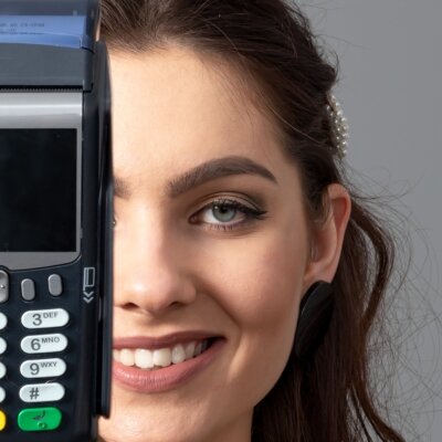    half a female face and a modern wireless bank card payment terminal, close-up Валерий