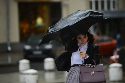    Девушка идет на Смоленской площади во время дождя в Москве. ©Кирилл Каллиников РИА Новости