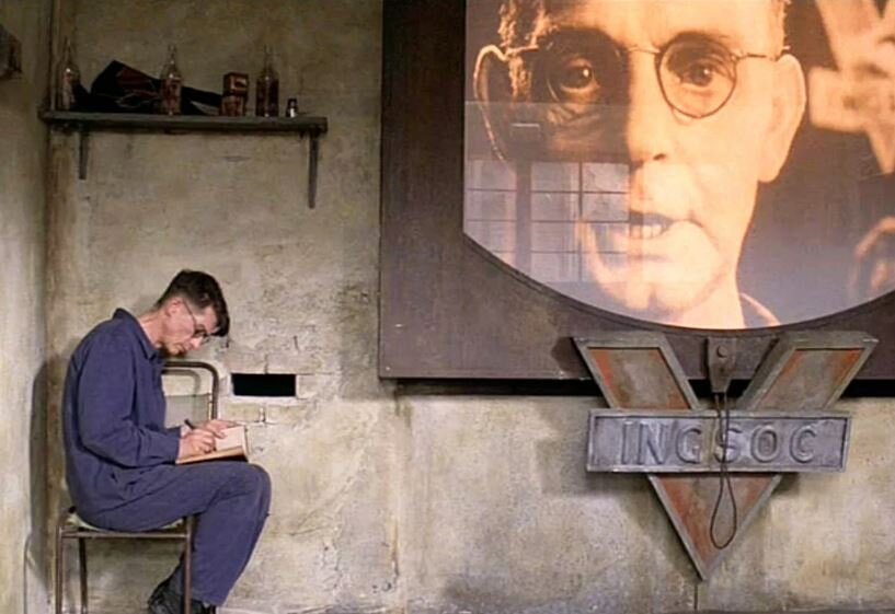 Телекран. В романе «1984» Джорджа Оруэлла телекраны были установлены во всех жилых и общественных помещениях, служили средством тотального контроля и слежения за людьми (иллюстрация  – кадр из кинофильма)