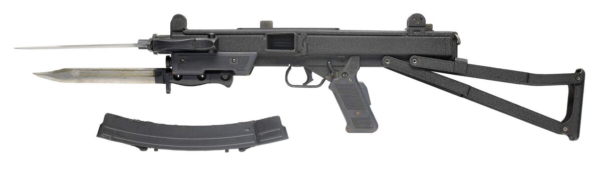 Пистолет пулемет с примкнутыми штык-ножами. Обратите внимание на переводчик режима огня и дополнительный выжимной предохранитель.