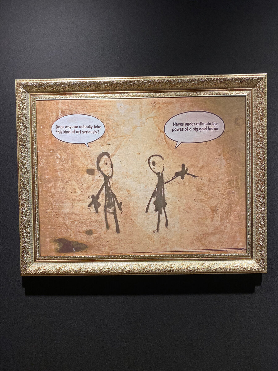 Картина Бэнкси с одноименной выставки на ВДНХ в 2022. Перевод: "-Неужели кто-то правда всерьез воспринимает это искусство? - Никогда не стоит недооценивать силу большой золотой рамы!"