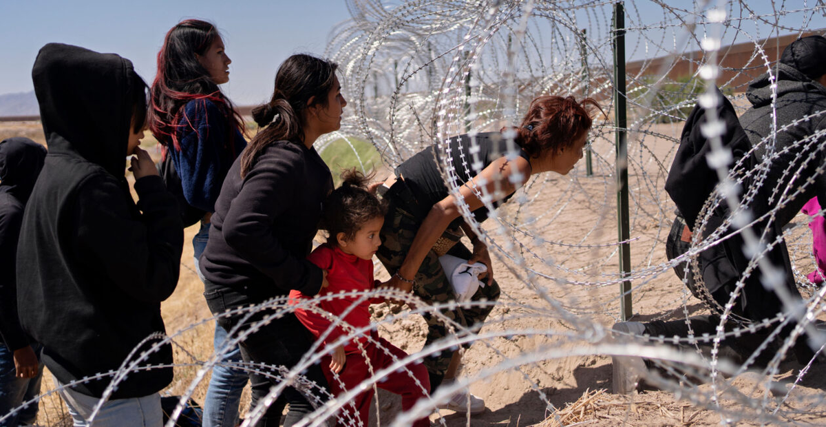 Иммиграционная политика президента Джо Байдена в отношении открытых границ настолько заманчива, что нелегальные иммигранты 11 мая рискуют получить серьезные травмы, пролезая через отверстие в заборе из колючей проволоки между Сьюдад-Хуаресом, Мексика, и Эль-Пасо, Техас. (Фото: Даниэль Вилласана/The Washington Post/Getty Images)