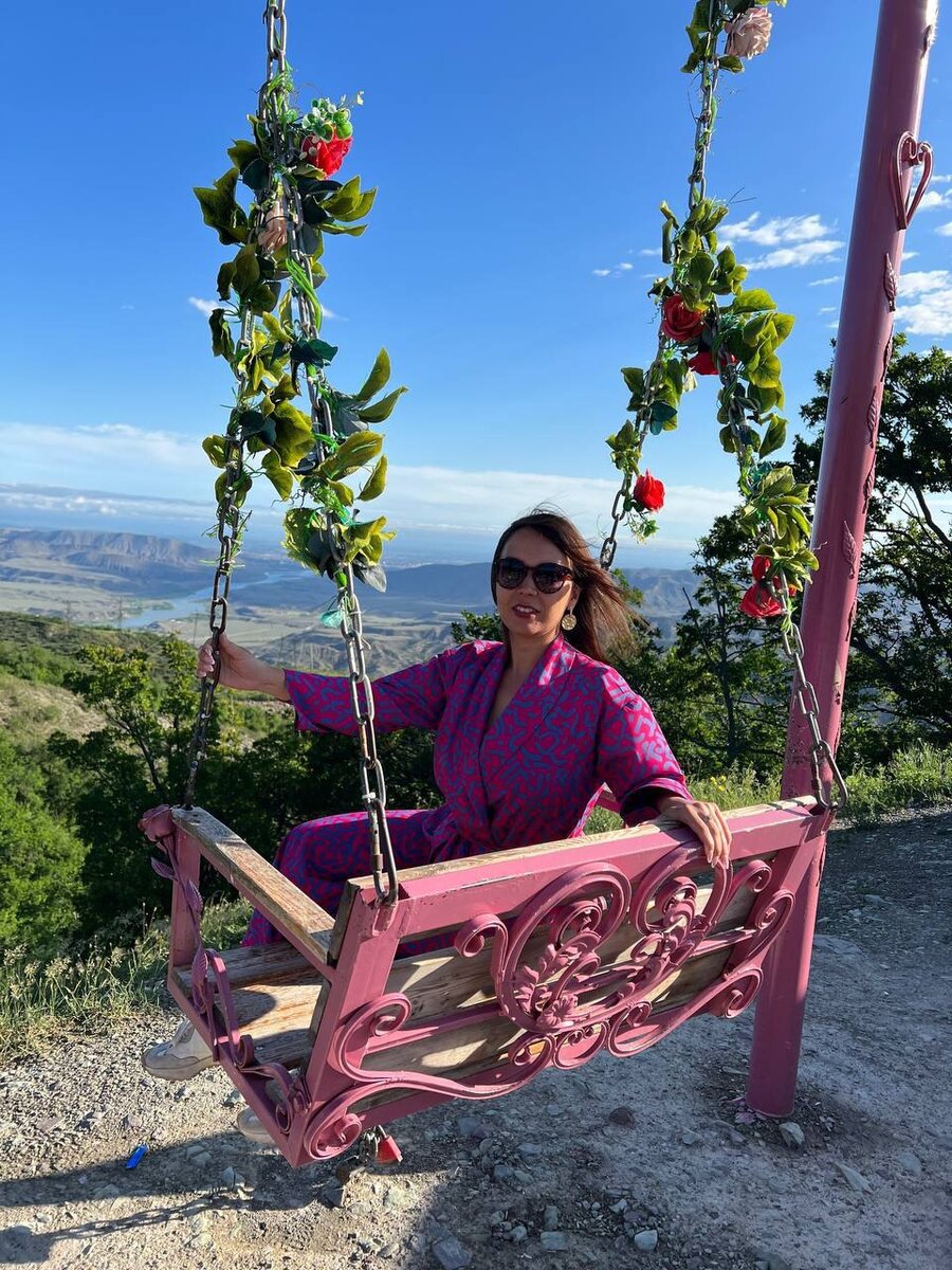 Красивая девушка на фоне зеленых гор, как цветок в руках джигита.