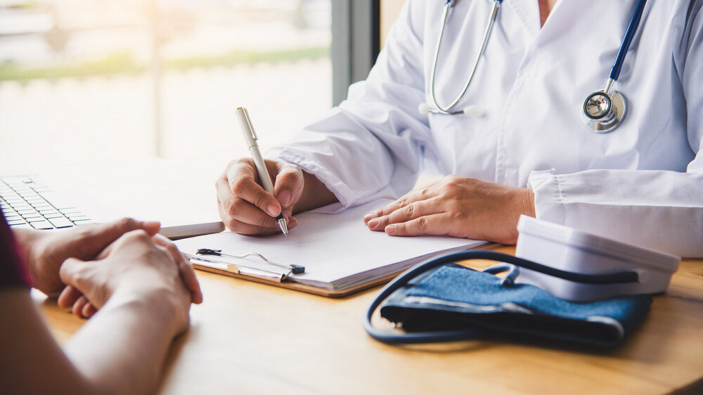    The doctor is discussing with the patient after a physical examination of the results and treatment guidelines. Игорь Умаров