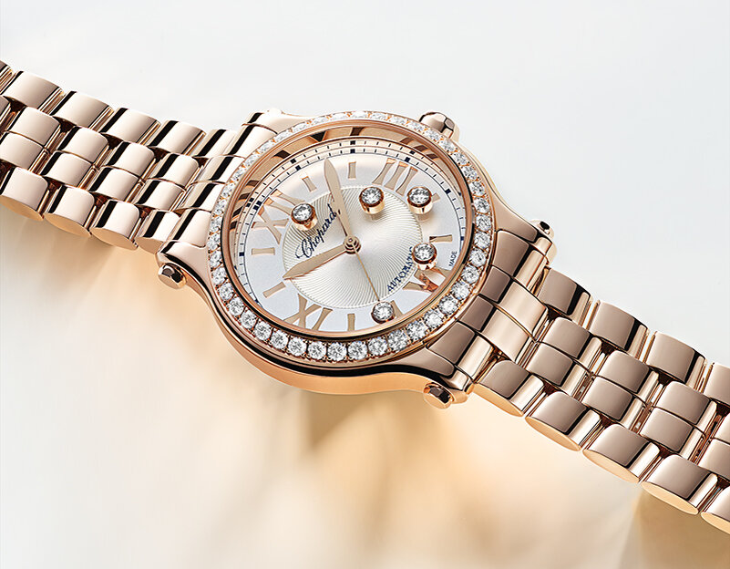Часы Chopard Happy Sport в 33 мм корпусе из розового золота с бриллиантовым безелем и 5 плавающими бриллиантами 
