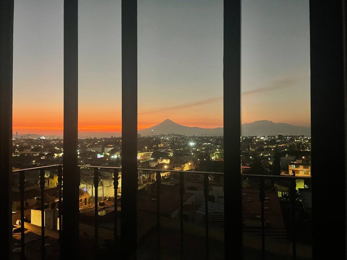 вид на Popocatépetl и Iztaccíhuatl из окна уютной однушки в Pueblo