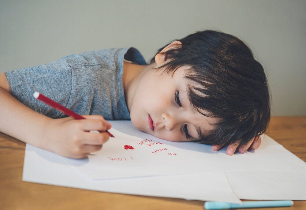 Boys lie. Boy Lies on Table. Little boy Desk writing. Children write Pencil Words. Lie face down with head Pointed down on Stanted surface.