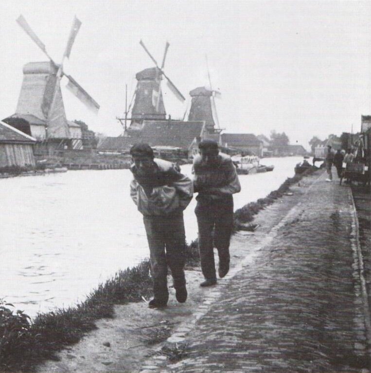 Fig. 01. 1900s Holland, three windmills, two male drawing canal boat.