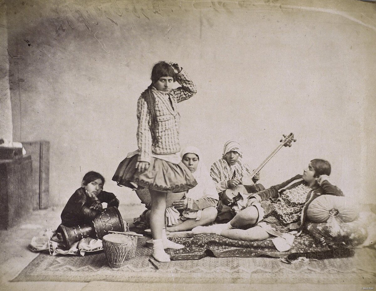 Пример фотографии, где как раз артист - мужчина в женской роли. А вот за ним в белом платке играет на инструменте женщина - в роли музыкантов женщины могли участвовать в театральном представлении. Лежит может быть зрительница. А может - и актер)