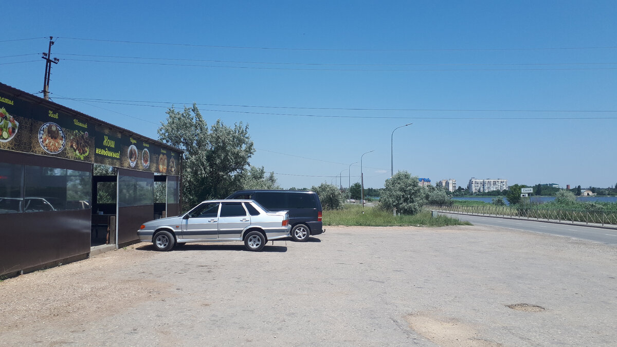 Слева кафе, справа видно озеро и город.